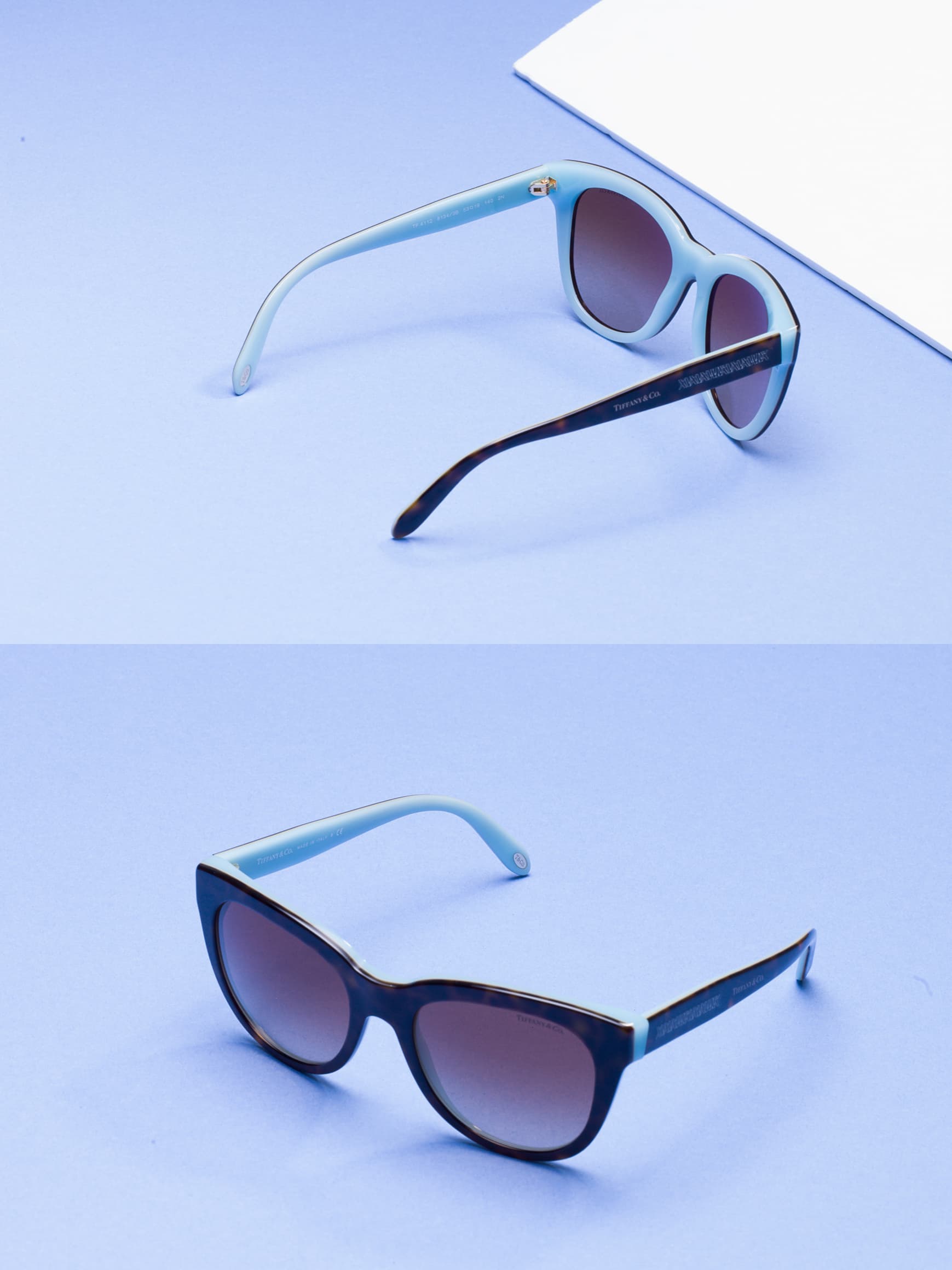 Two pairs of sunglasses arranged on a turquoise studio background — before retouching