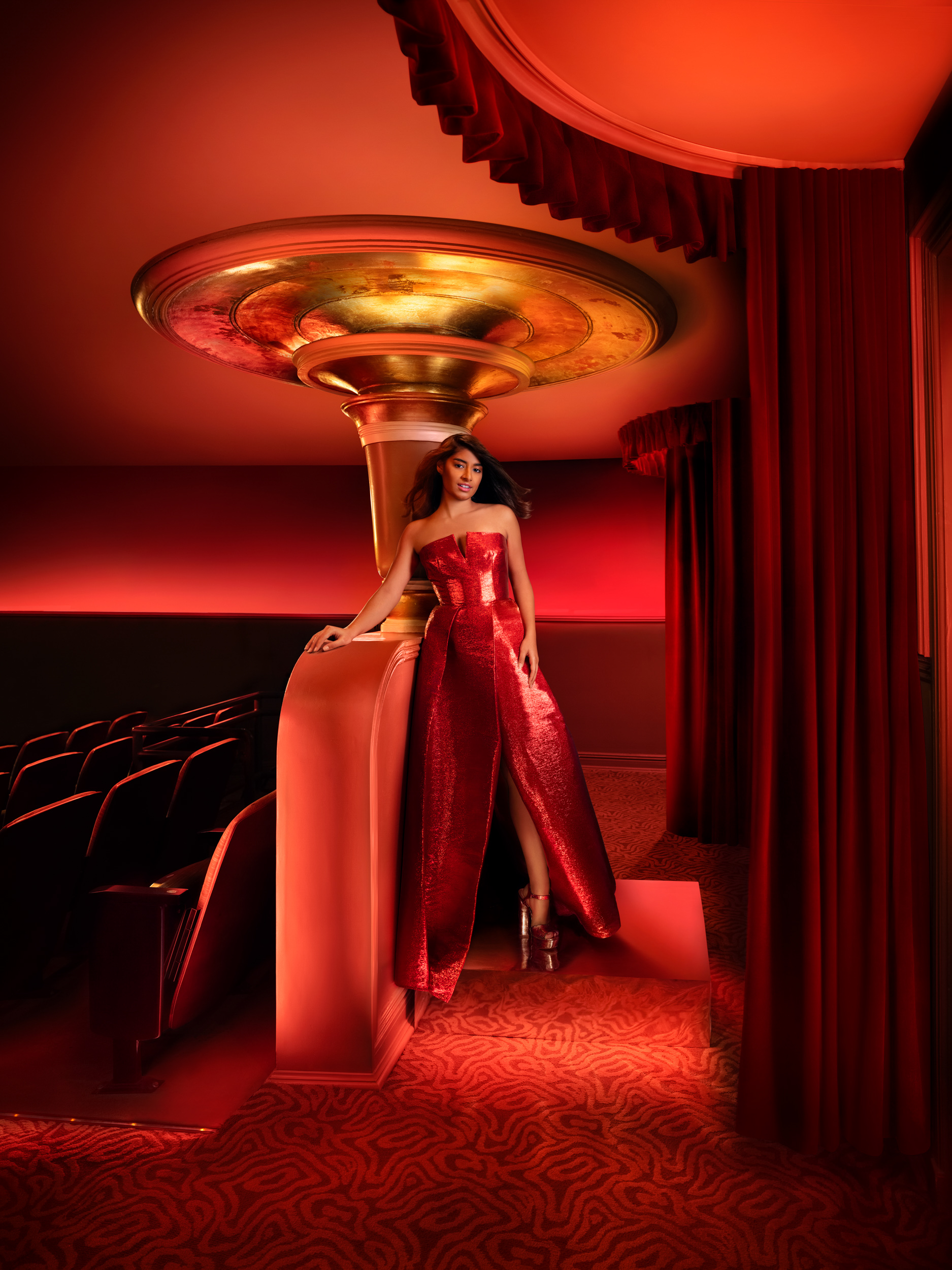 Aleena Bashir posing in a red gown inside Trustees Theater for the 2024 SCAD Savannah Film Festival